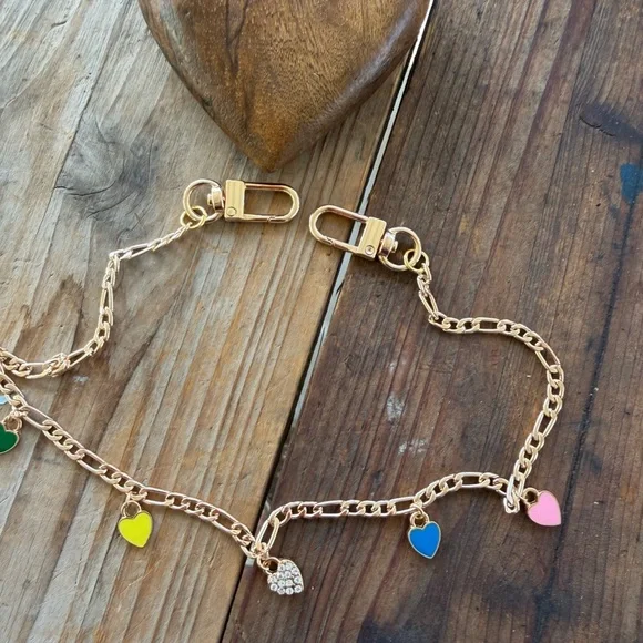 Gold tone phone accessory with enameled colored hearts . - Picture 1 of 3